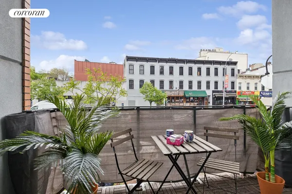a view of balcony with furniture and city view