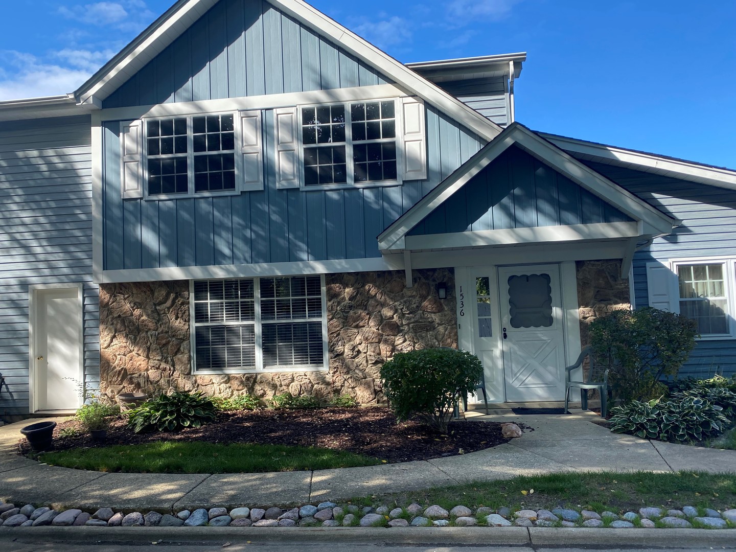 a front view of a house with garden