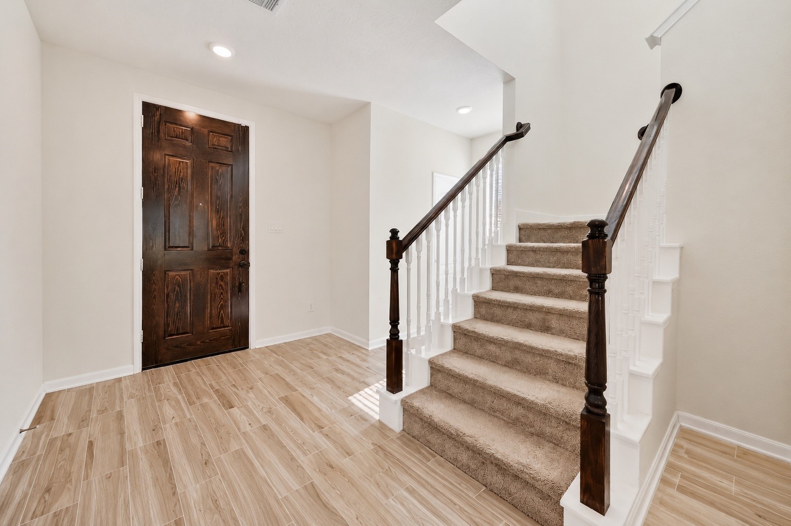 2107 Parnevik Place Conroe, TX 77304 - Photo 7 of 44 The entry foyer is the perfect place to tuck the staircase to the 2nd floor bedrooms and the convenient 1/2 bath is beyond and to the right of the front door