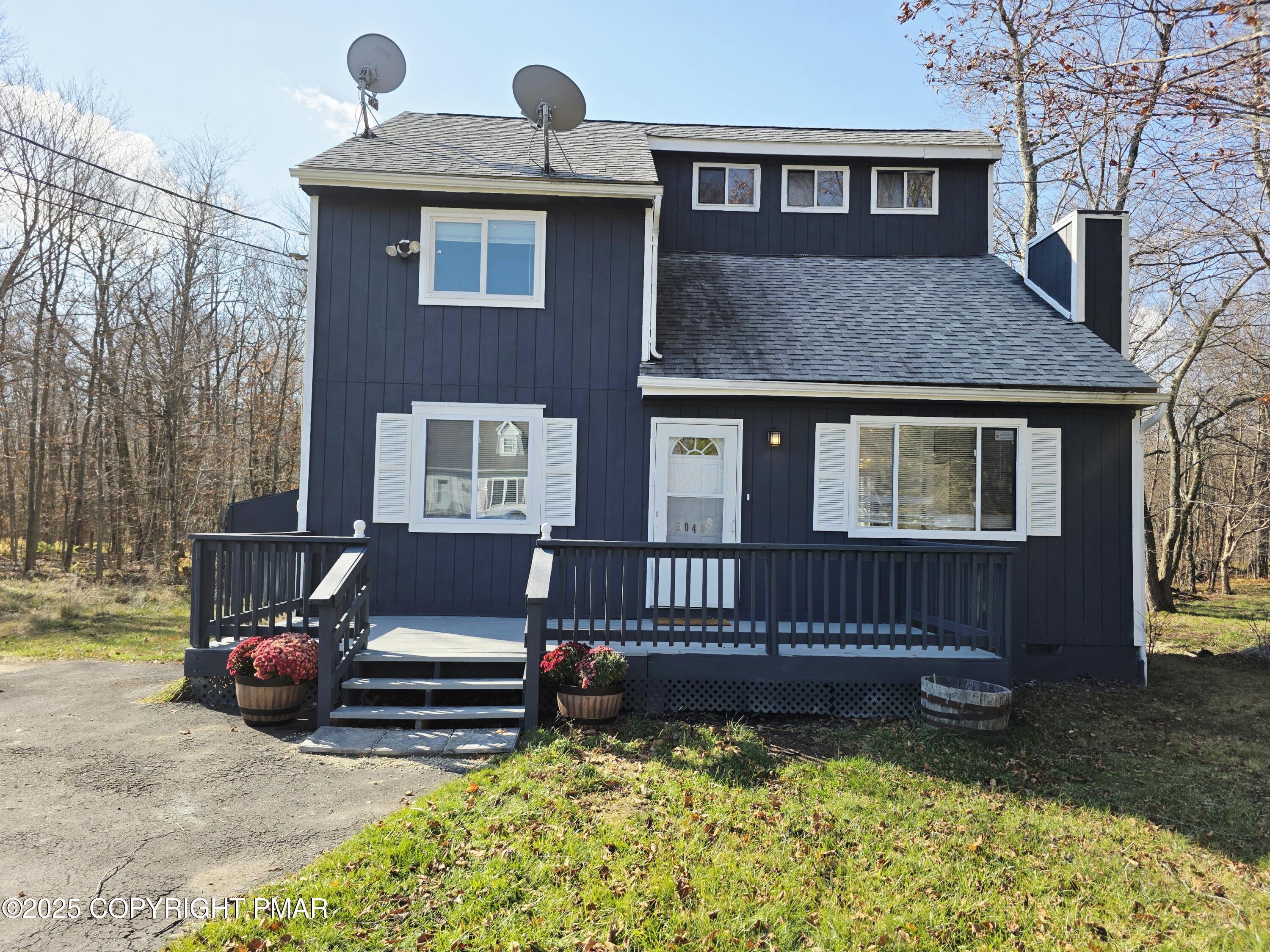 a view of a house with a bed and wooden floor