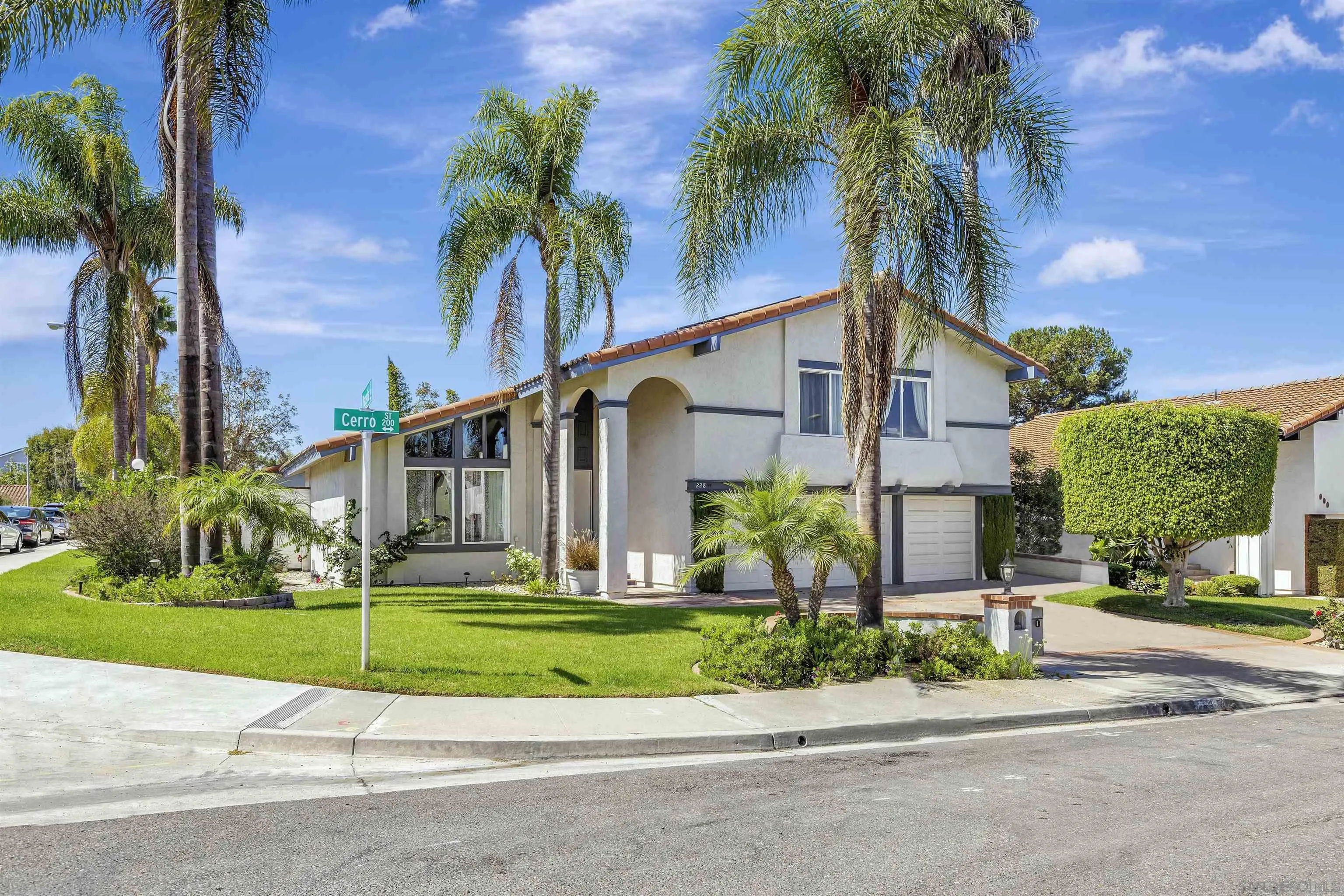 228 Cerro Street Encinitas, CA 92024 - Photo 7 of 9 a front view of a house with a garden and a yard