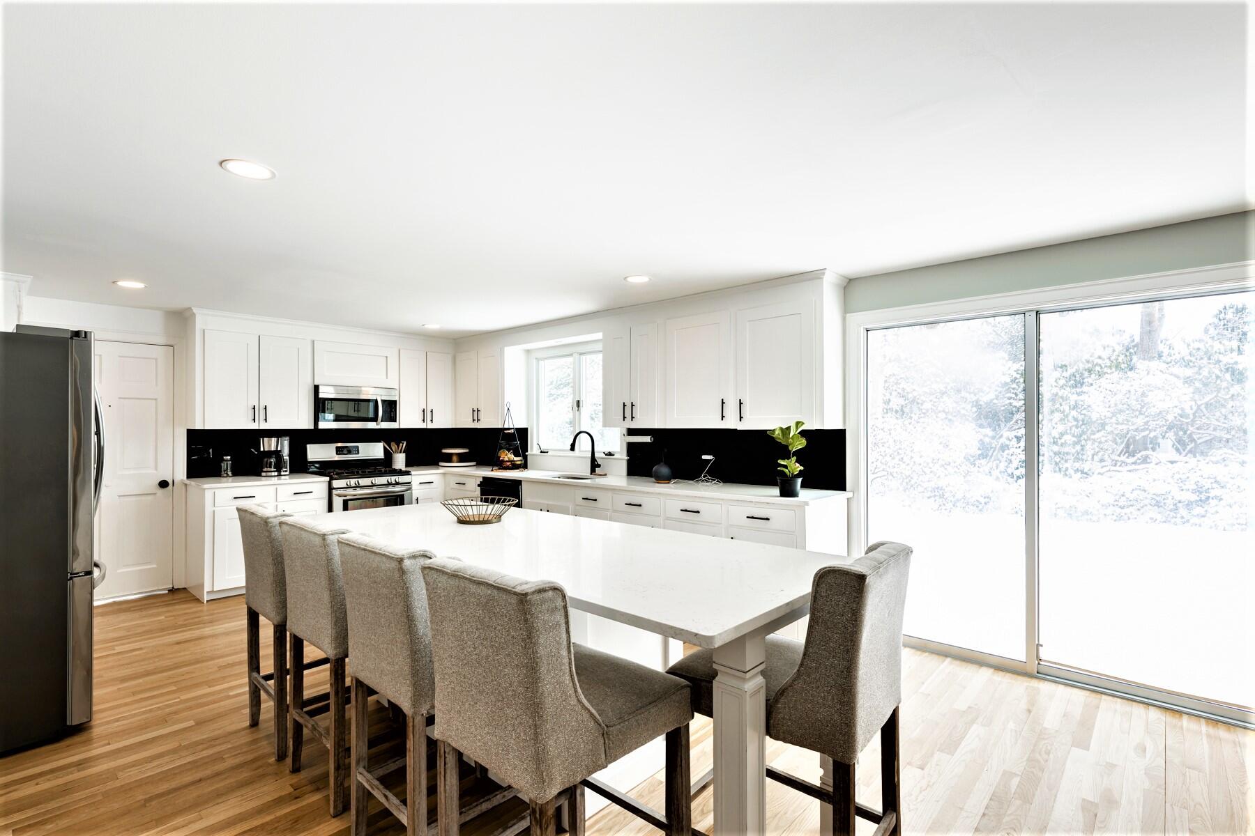 53 Rolling Hitch Road Centerville, MA 02632 - Photo 5 of 27 a kitchen with stainless steel appliances a dining table chairs and a refrigerator