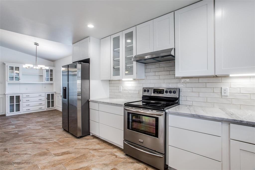 6926 Northwood Road Dallas, TX 75225 - Photo 15 of 29 a kitchen with stainless steel appliances granite countertop a refrigerator sink and stove