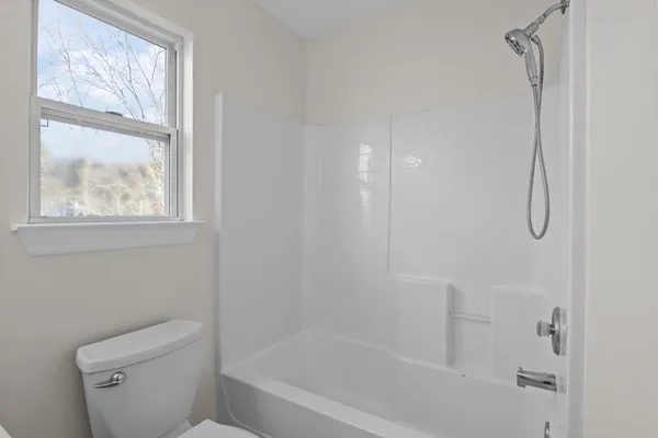 a bath room with a toilet and a bath tub