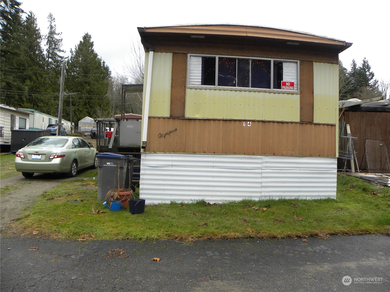 15503 Cedar Park Road Southeast, Unit 14 Olalla, WA 98359 - Photo 2 of 31 a front view of a house with a garden