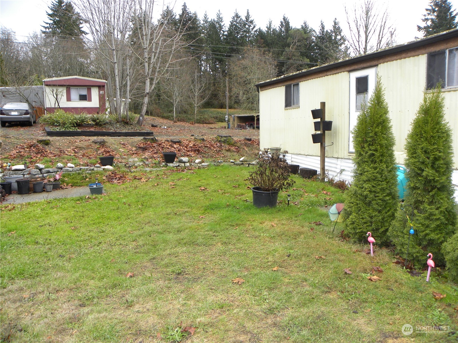 15503 Cedar Park Road Southeast, Unit 14 Olalla, WA 98359 - Photo 22 of 31 a backyard of a house with table and chairs