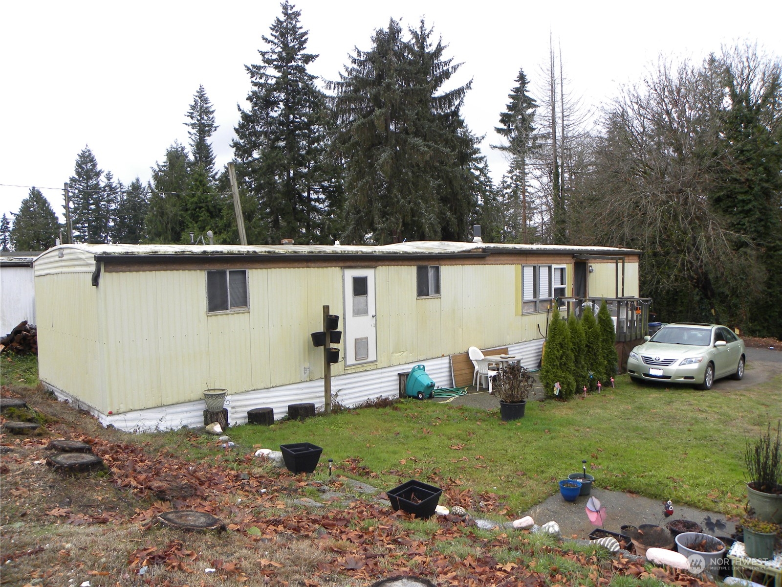 15503 Cedar Park Road Southeast, Unit 14 Olalla, WA 98359 - Photo 25 of 31 a view of a backyard with plants and a patio