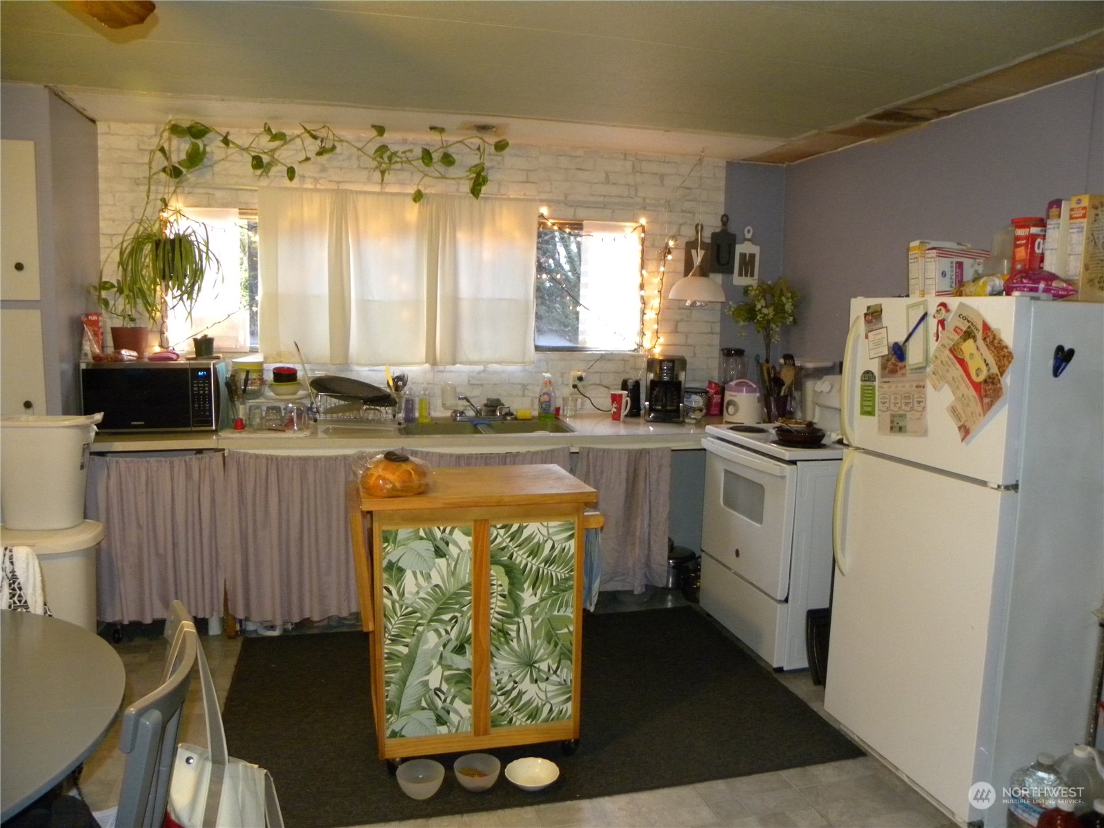 15503 Cedar Park Road Southeast, Unit 14 Olalla, WA 98359 - Photo 4 of 31 a kitchen with a sink cabinets and window