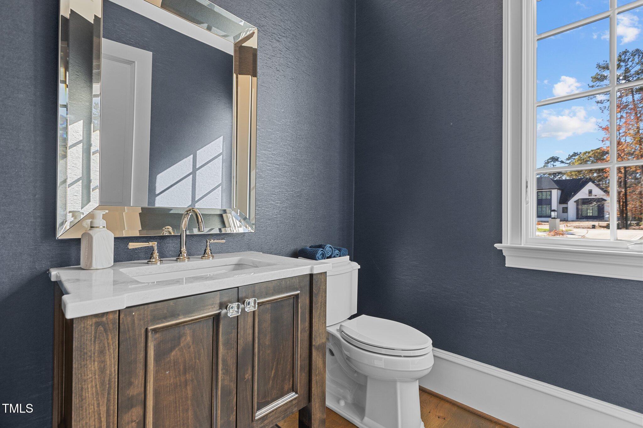 1416 Bailey Hill Drive Raleigh, NC 27614 - Photo 27 of 71 a bathroom with a sink vanity mirror and toilet
