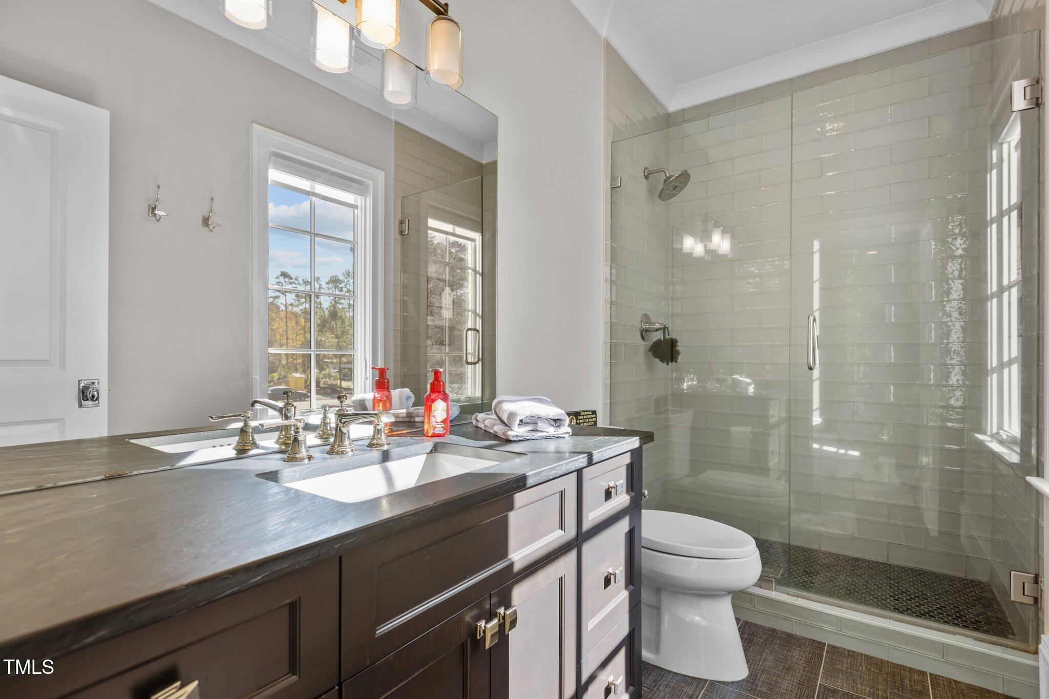 1416 Bailey Hill Drive Raleigh, NC 27614 - Photo 42 of 71 a bathroom with a double vanity sink toilet mirror and shower