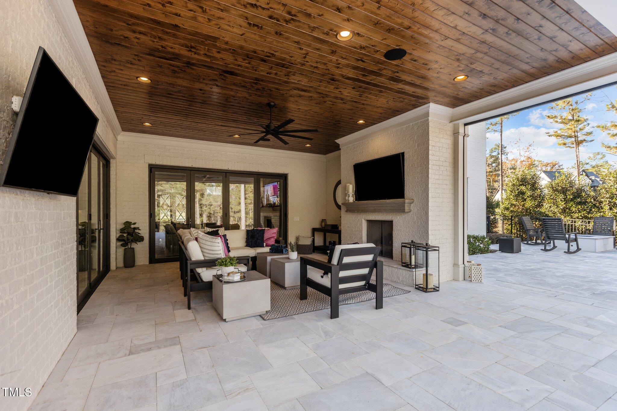 1416 Bailey Hill Drive Raleigh, NC 27614 - Photo 52 of 71 a living room with patio furniture and a flat screen tv