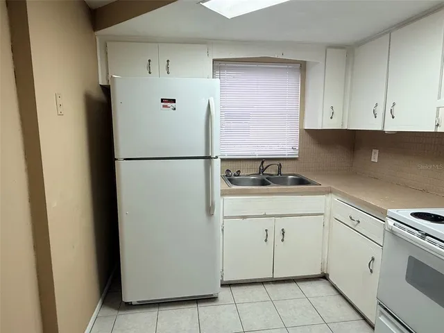 a white refrigerator freezer sitting inside of a kitchen