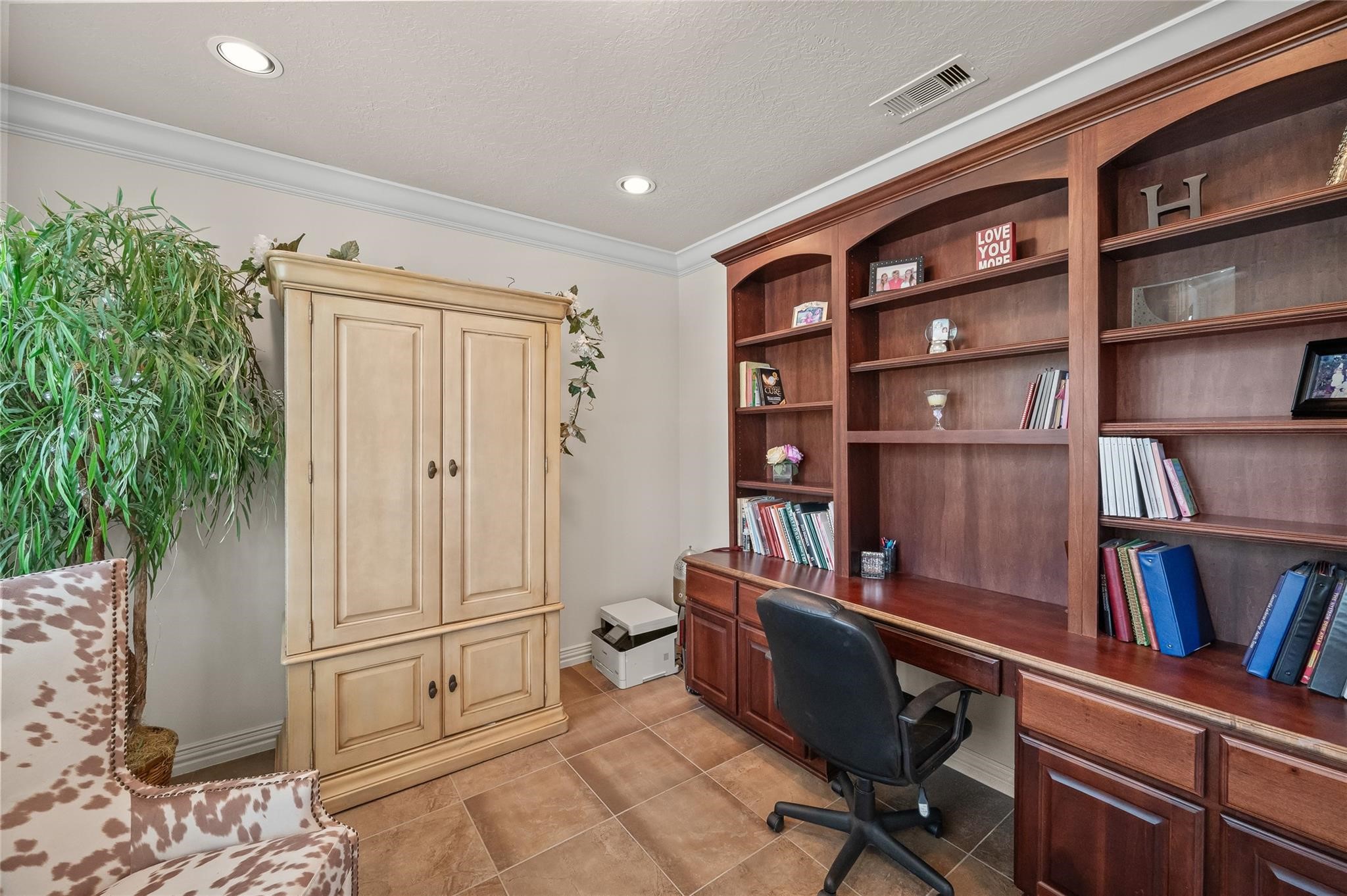 2127 Thicket Ridge Lane Houston, TX 77077 - Photo 9 of 50 Built in Benedettini cabinetry is featured in this in-home library/study. There are tons of shelving, four small drawers and four large cabinets under the drawers.