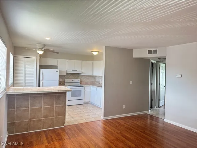 a view of kitchen with cabinets and wooden floor