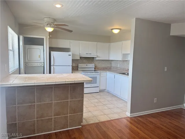 a kitchen with kitchen island a sink stainless steel appliances and cabinets