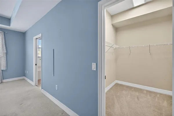 an empty room with chandelier fan