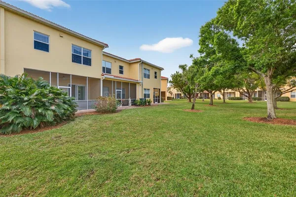 an aerial view of residential houses with outdoor space and river