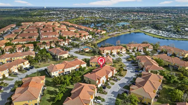 an aerial view of residential houses with outdoor space and swimming pool