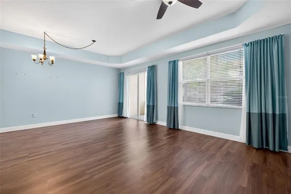 a view of a kitchen with a white cabinets and wooden floor