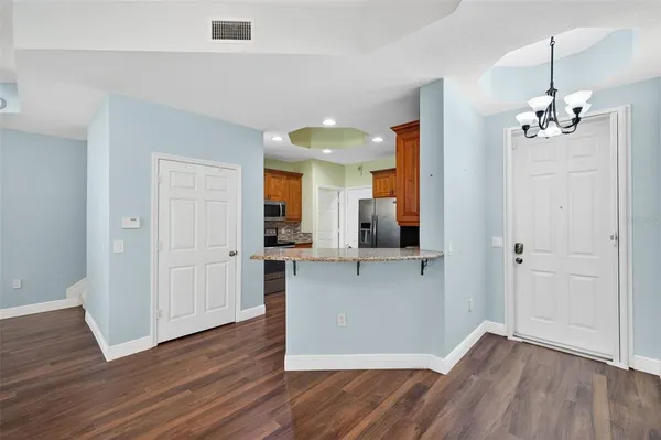 a view of empty room with wooden floor and ceiling fan