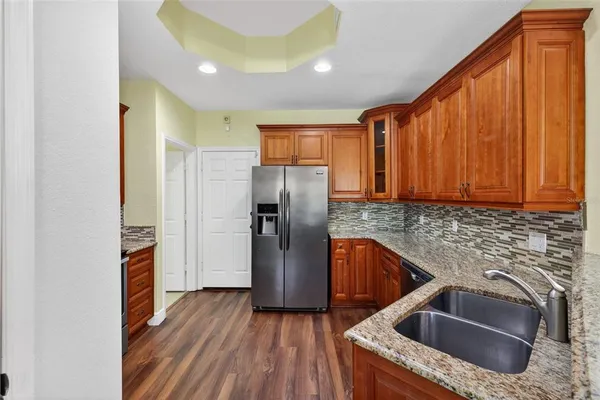a kitchen with stainless steel appliances a stove and a sink