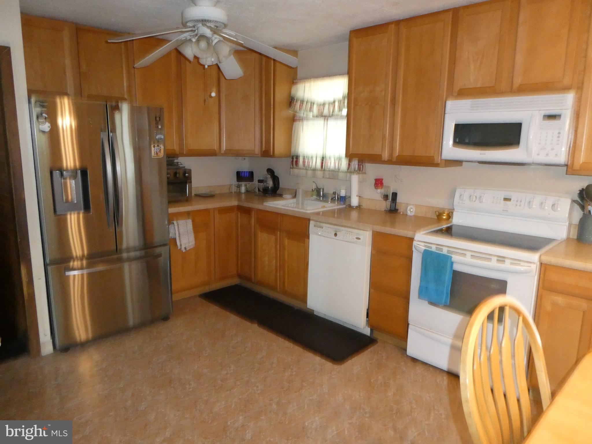 2 Pineview Avenue Berlin, NJ 08009 - Photo 3 of 19 a kitchen with stainless steel appliances a sink cabinets and a refrigerator