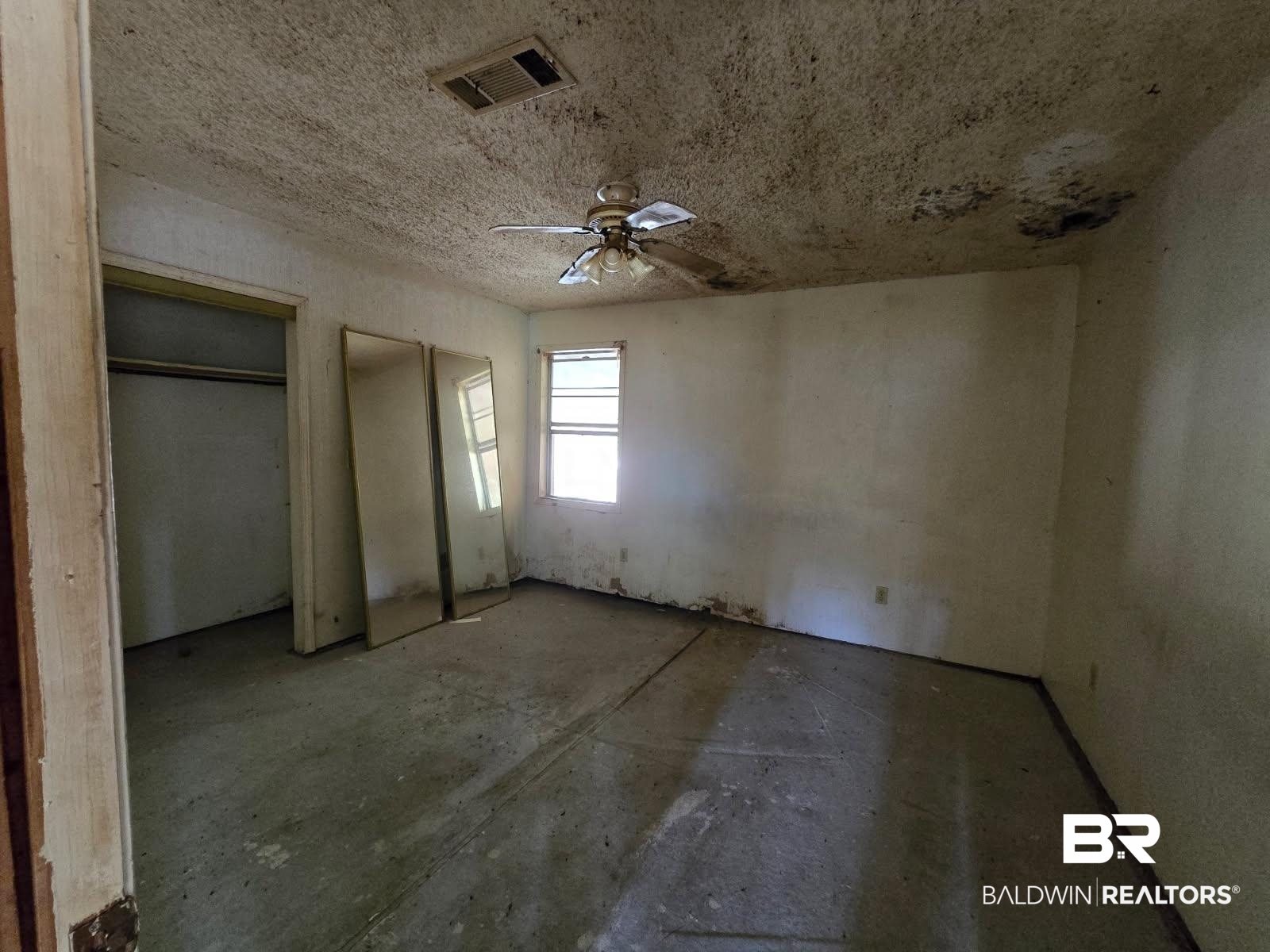 4072 Appleton Road Brewton, AL 36426 - Photo 4 of 7 Unfurnished bedroom featuring two closets, concrete floors, and ceiling fan