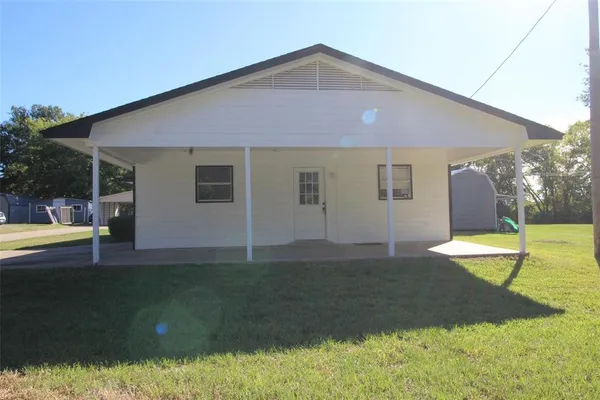 a kitchen with wooden floors and white appliances