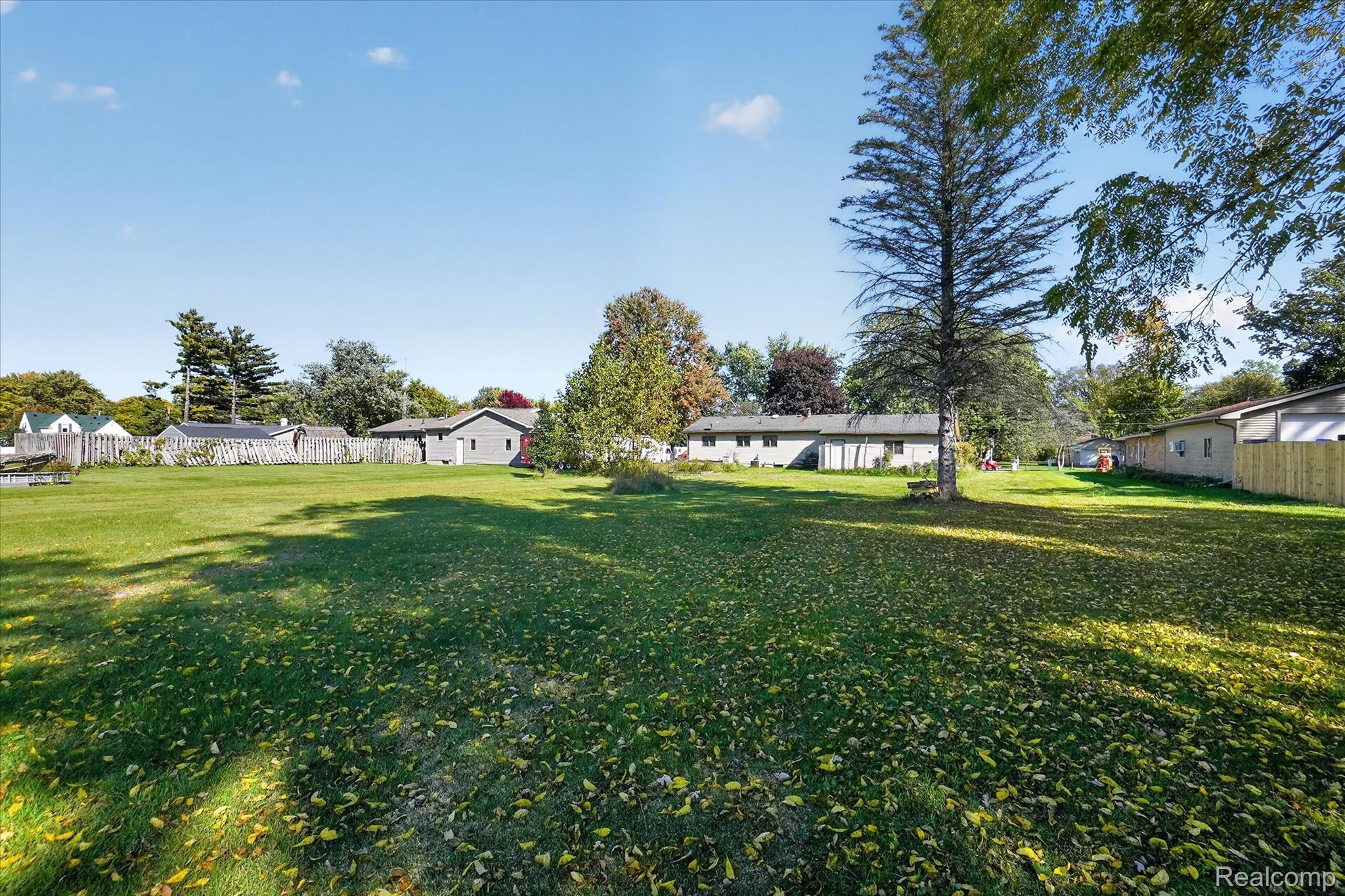 7178 Riegler Street Grand Blanc, MI 48439 - Photo 2 of 31 Expansive grassy lawn with mature trees and partial fencing