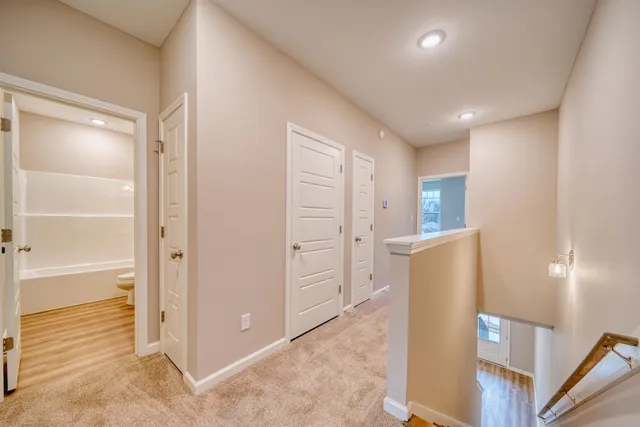 an empty room with closet and windows