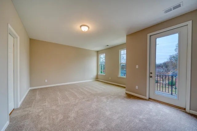a view of an empty room with glass door