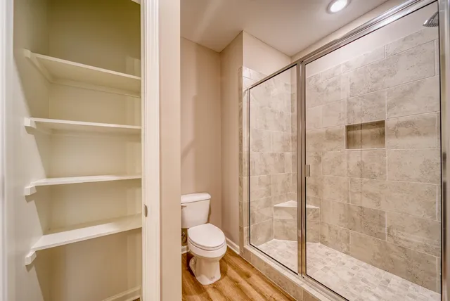 a bathroom with a toilet and a shower