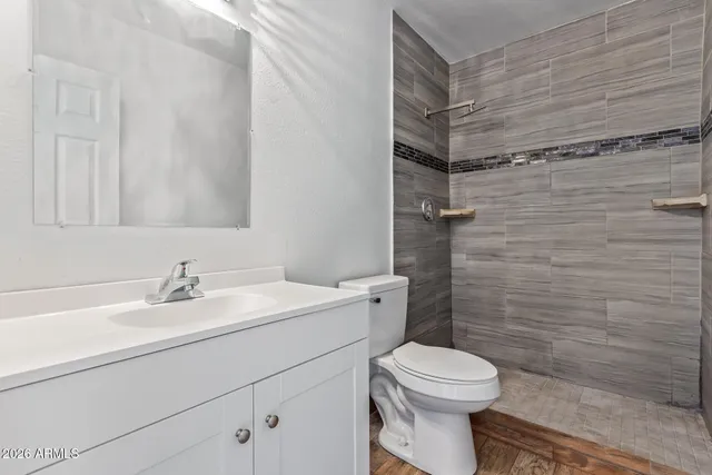 a bathroom with a sink toilet and shower