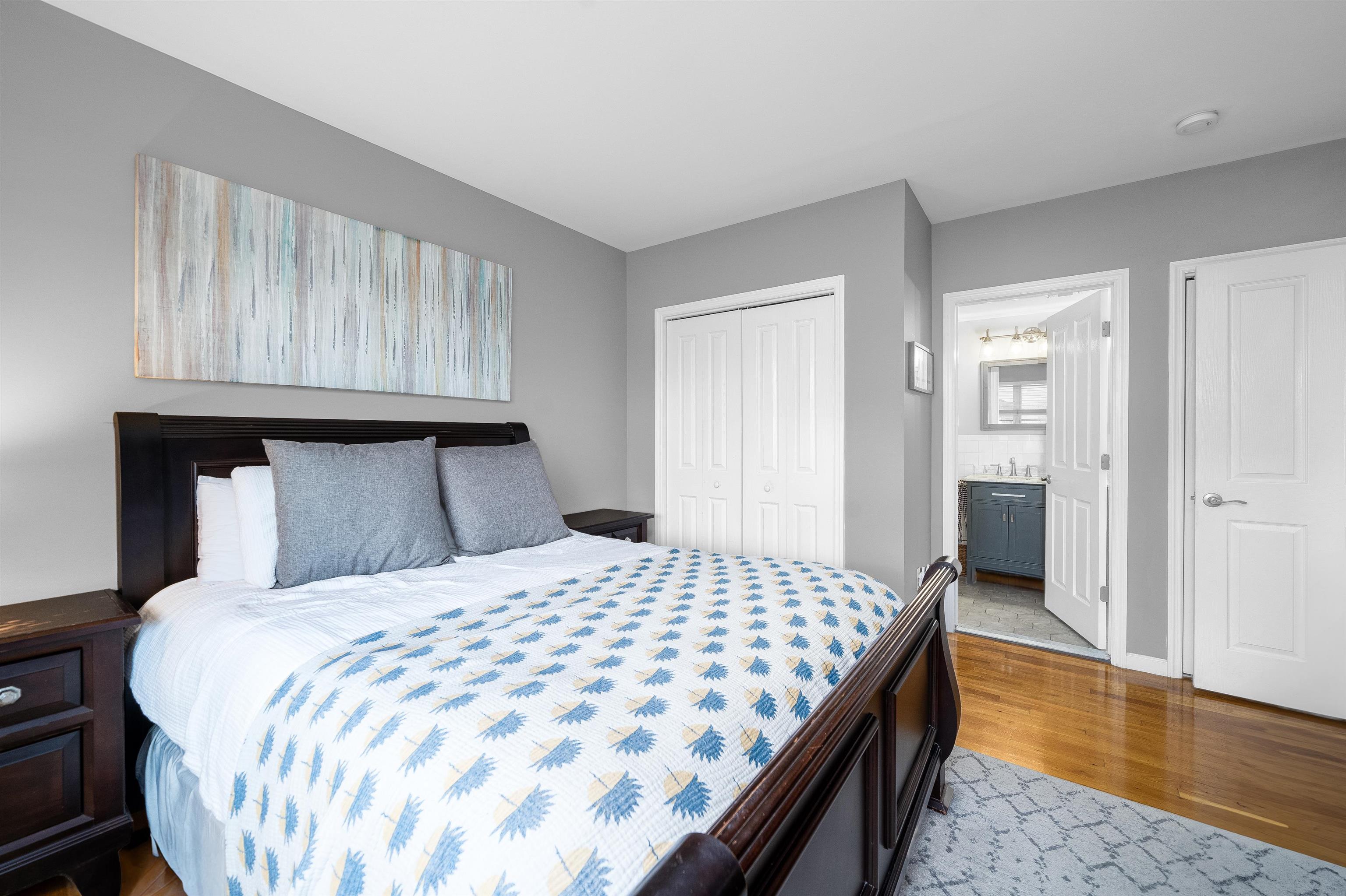 536 Grand Street, Unit 403 Hoboken, NJ 07030 - Photo 7 of 15 a bedroom with a large bed and wooden floor