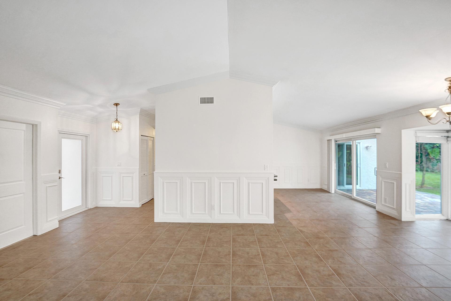 2941 Northwest 24th Way Boca Raton, FL 33431 - Photo 11 of 53 an empty room with windows and pillars in it