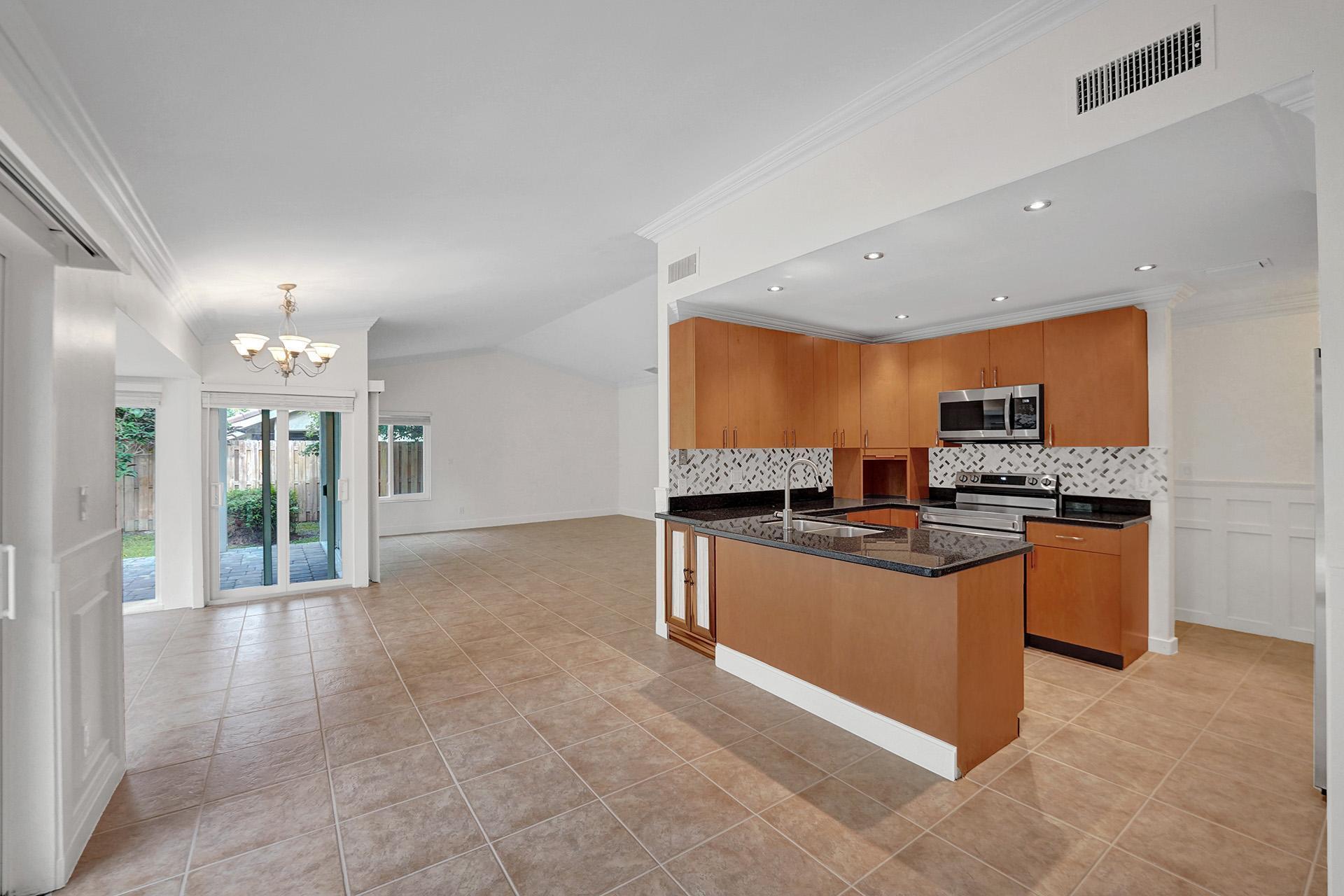 2941 Northwest 24th Way Boca Raton, FL 33431 - Photo 17 of 53 a kitchen with stainless steel appliances granite countertop a stove top oven a sink and dishwasher