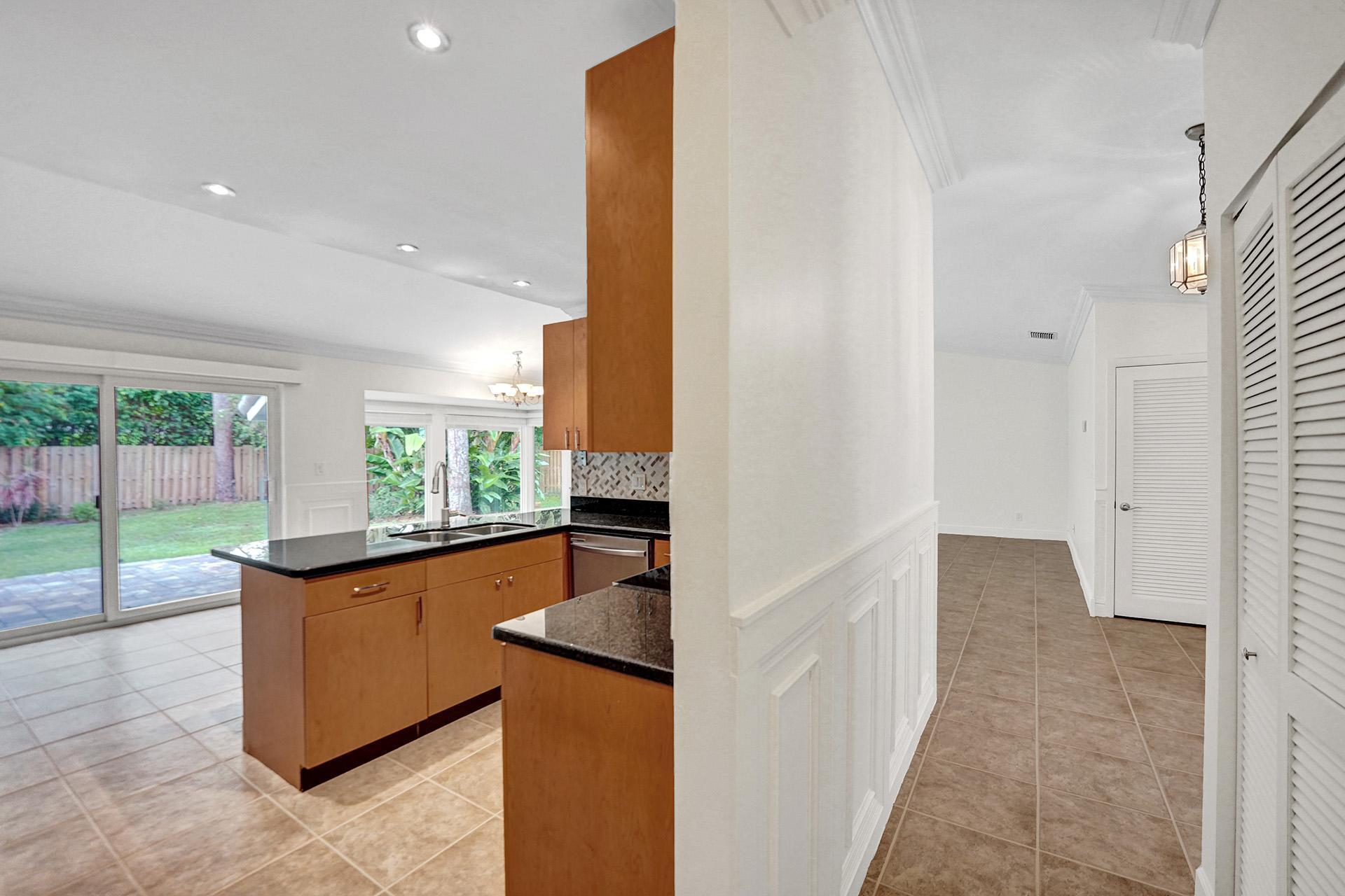 2941 Northwest 24th Way Boca Raton, FL 33431 - Photo 21 of 53 a kitchen with granite countertop sink and cabinets