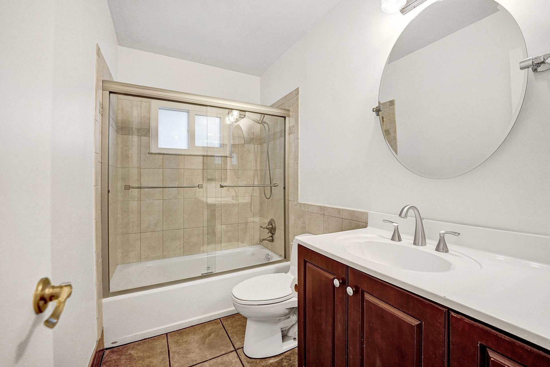 2941 Northwest 24th Way Boca Raton, FL 33431 - Photo 32 of 53 a bathroom with a sink a toilet and shower