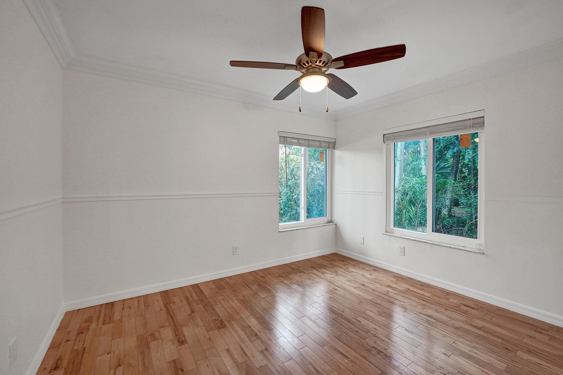 2941 Northwest 24th Way Boca Raton, FL 33431 - Photo 38 of 53 a view of empty room with wooden floor and fan