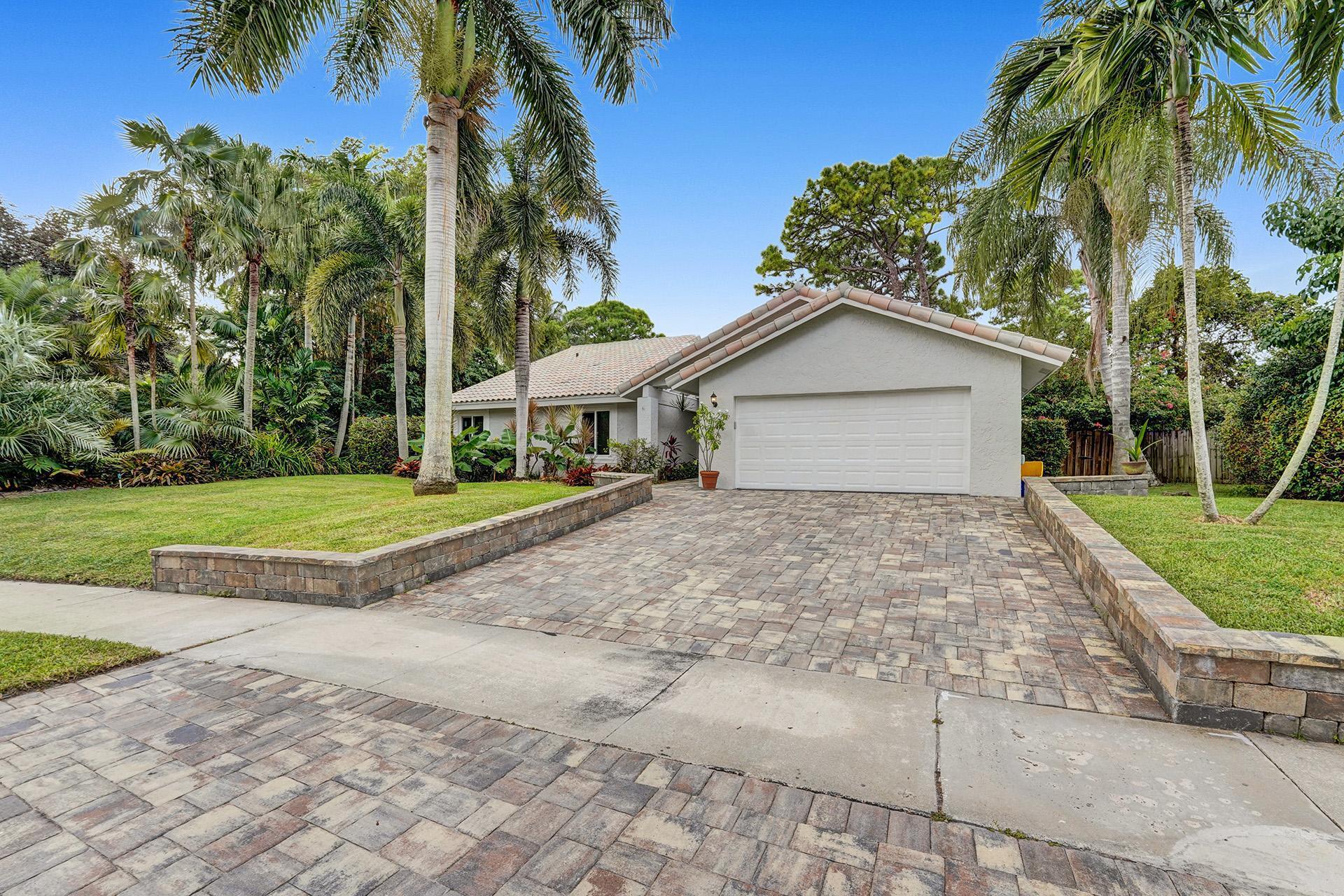 2941 Northwest 24th Way Boca Raton, FL 33431 - Photo 4 of 53 a view of a house with a yard and palm trees