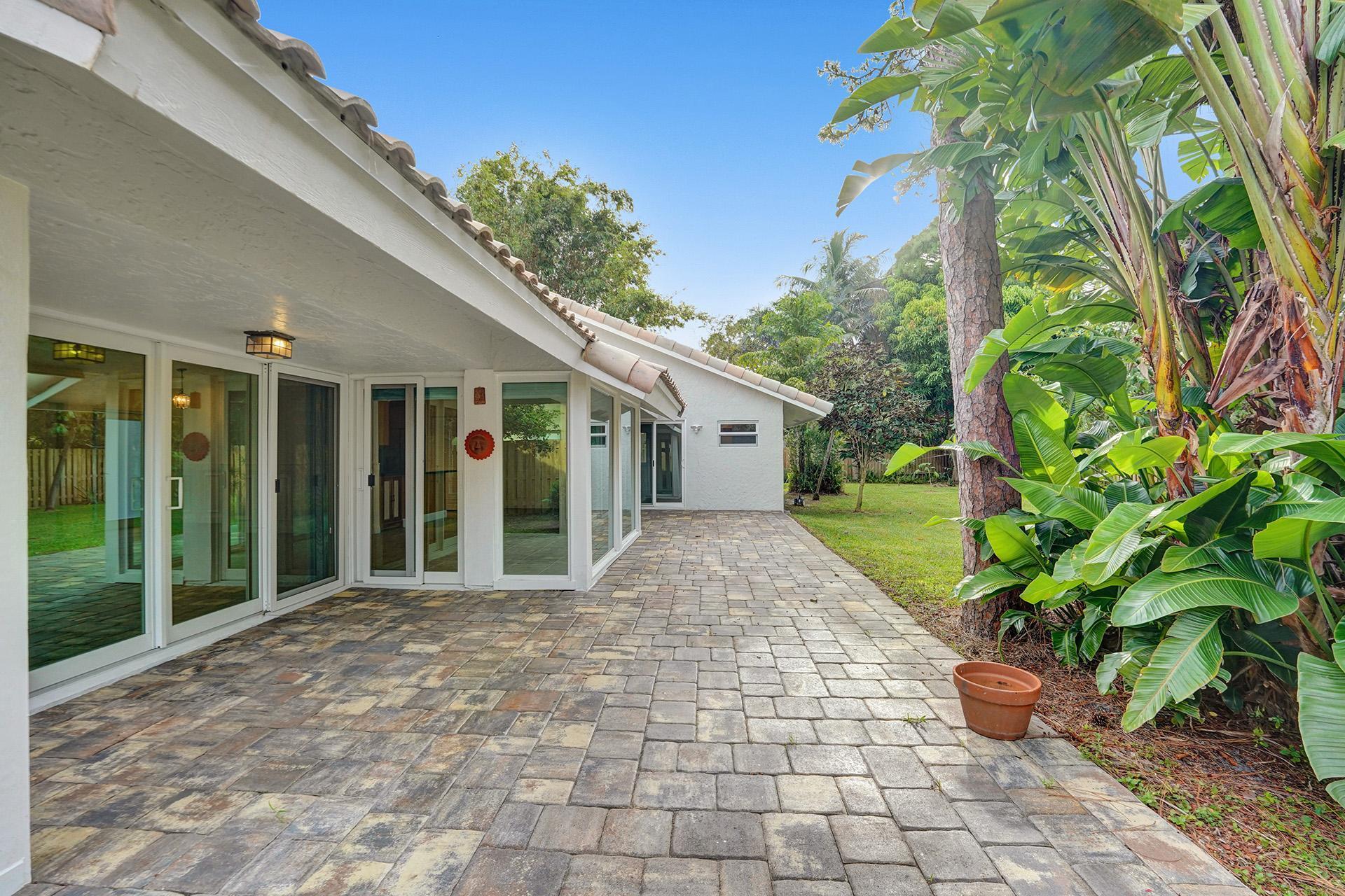 2941 Northwest 24th Way Boca Raton, FL 33431 - Photo 52 of 53 a front view of a house with garden
