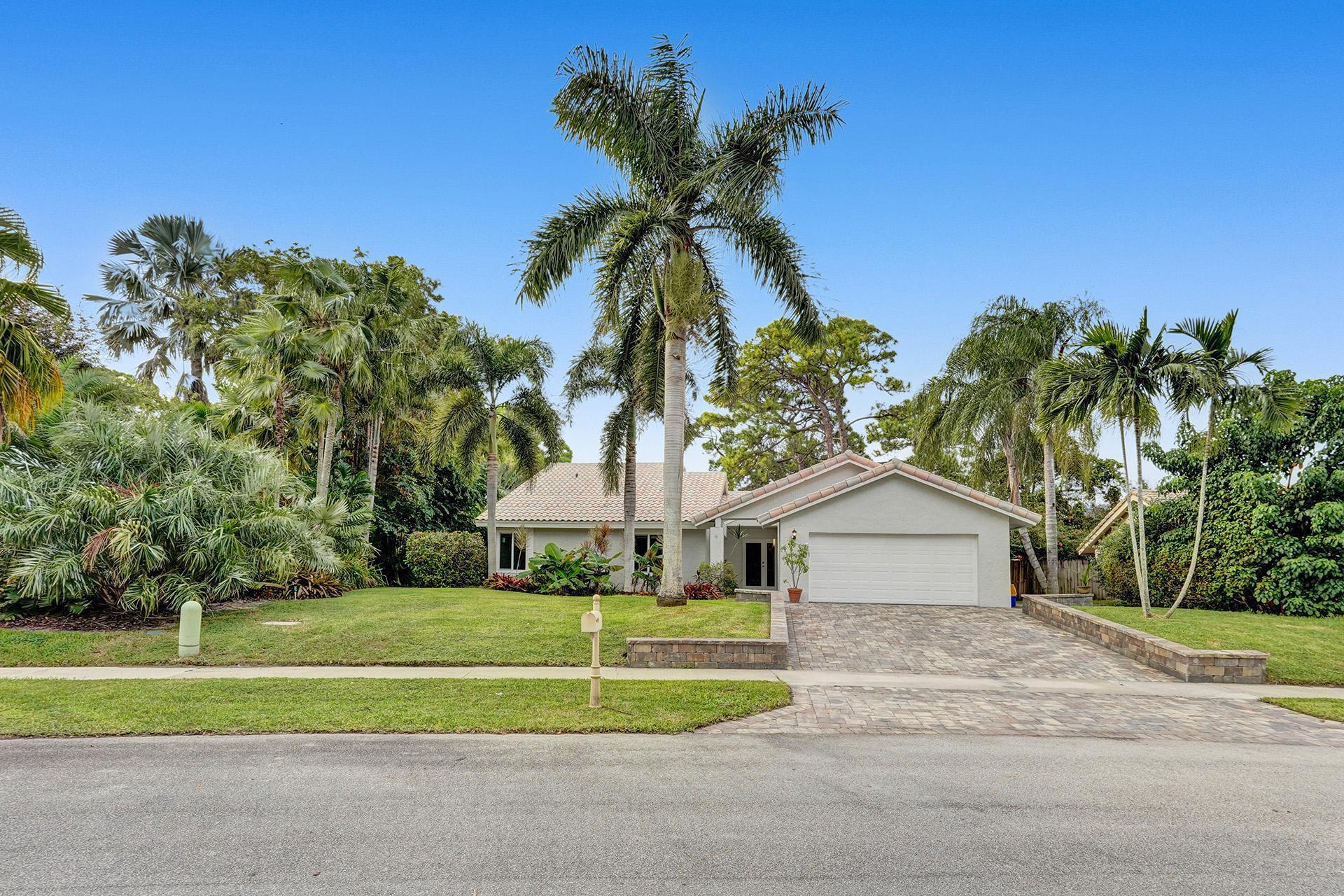 2941 Northwest 24th Way Boca Raton, FL 33431 - Photo 53 of 53 a front view of a house with a yard and garage