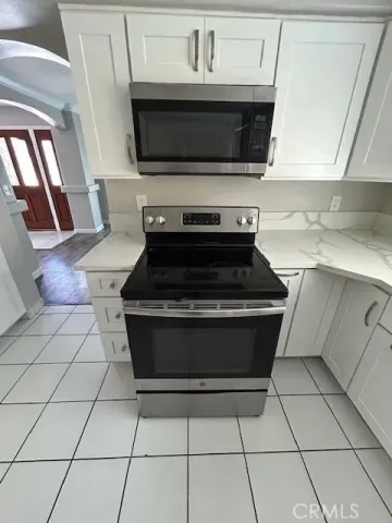 a stove top oven sitting inside of a kitchen