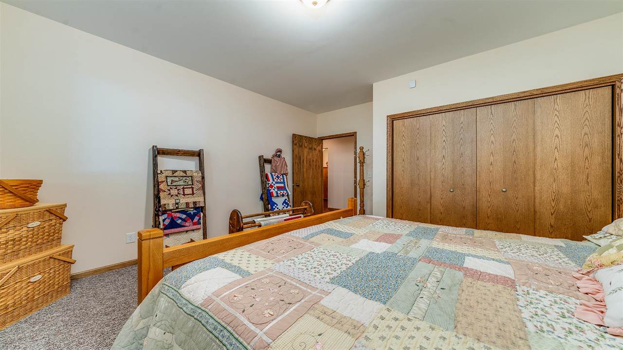 15406 Wheeler Road Durand, IL 61024 - Photo 29 of 34 a bedroom with a bed and a dresser in it