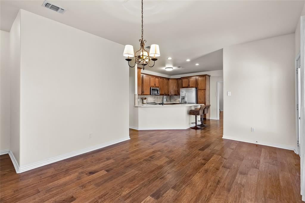 1308 Madeline Street Commerce, TX 75428 - Photo 17 of 37 a view of a kitchen with a dishwasher and wooden floor
