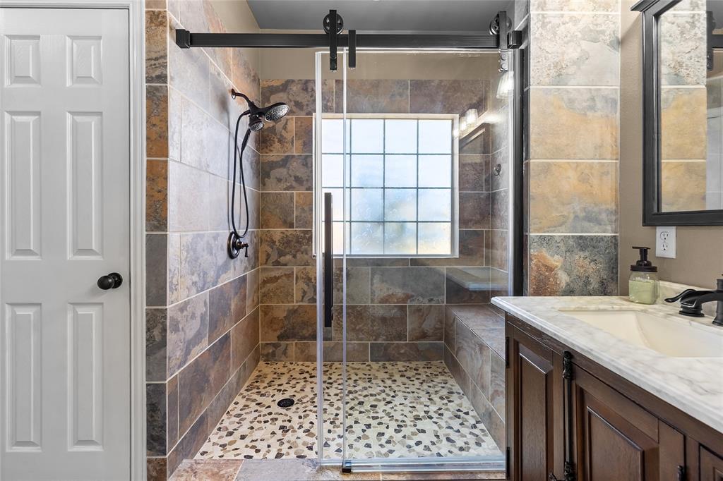 1308 Madeline Street Commerce, TX 75428 - Photo 23 of 37 a bathroom with a sink and a shower