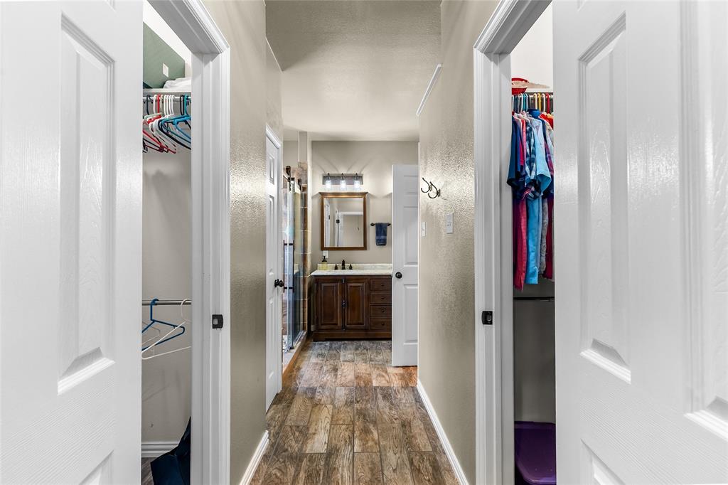 1308 Madeline Street Commerce, TX 75428 - Photo 24 of 37 a view of a hallway with wooden floor and a bathroom