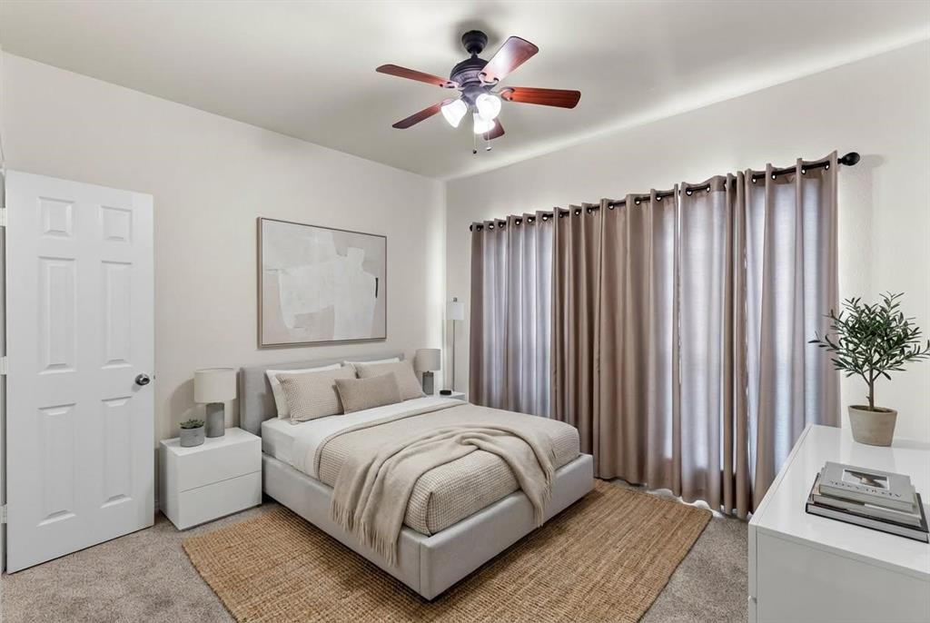 1308 Madeline Street Commerce, TX 75428 - Photo 25 of 37 a bedroom with a large bed and a chandelier