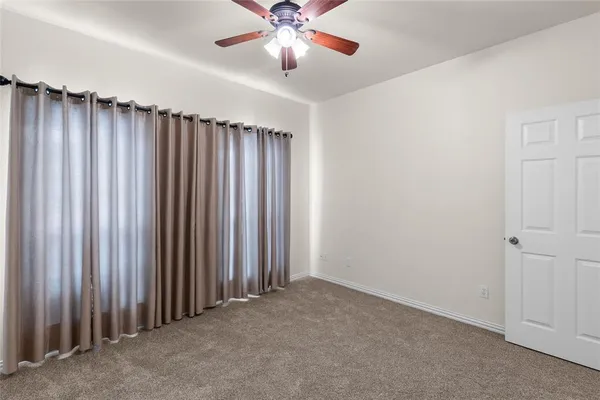 an empty room with floor and windows
