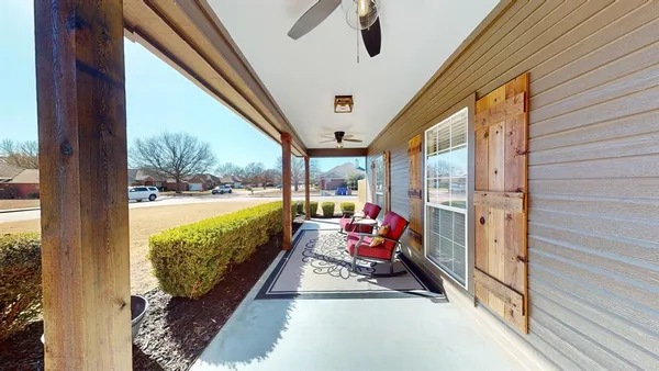 a balcony with furniture and garden view